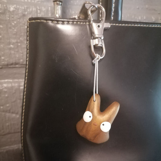 Pronssin värinen laukkukoru & avaimenperä laukussa